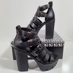 Primadonna Collection Strappy Black Rubberized Platform Sandals With Side Triple Buckle And 4 Inch Heels. Toebox Has A 1.25 Inch Platform. Multiple Euro Sizes 36, 38, 39. Your Sandals Will Be Shipped Day They Are Paid Or Next Business Day. Strapped Sandals With Buckle Closure For Party, Party Heels With Buckle Closure And Straps, Party Heels With Buckle And Straps, Chic Black Strapped Sandals, Chic Black Strapped Heels, Edgy High Heel Sandals With Buckle Closure, Edgy Open Toe Heels With Buckle Closure, Punk Style Platform Heels With Open Toe, Black Strapped Synthetic Heels