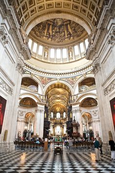 the inside of a church with people standing in it