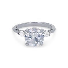 a white gold engagement ring with three diamonds on the band and an oval center stone