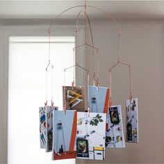 a mobile with pictures hanging from it's sides