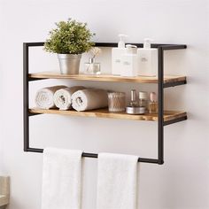 two wooden shelves with towels and soaps on them