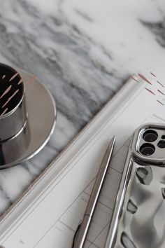 a marble counter top with metal utensils on it