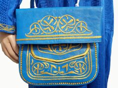 This Moroccan leather bag is absolutely beautiful and carries cultural heritage with it. Stylish traditional slim and classic berber bag, handmade by skilled artisan with love and care, from premium goat leather and the embroidery is cactus silk. It becomes hard to find it Wear your new favourite sustainable fashion piece as a shoulder bag or as a cross-body bag, it will draw all eyes on you and bring your look to life. It has a main fold over the compartment, and an open back compartment and 2 Traditional Blue Pouch Shoulder Bag, Festival Embroidered Leather Shoulder Bag, Blue Luxury Artisan Bag, Bohemian Blue Embroidered Shoulder Bag, Luxury Blue Bohemian Shoulder Bag, Moroccan Blue, Moroccan Leather, Cactus Silk, Leather Cross