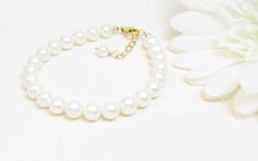 "A classic and simple real pearl bracelet. Created with Grade-A 6.5mm round freshwater pearls and a 14K gold-filled lobster clasp with a 1/2\" extender chain. All metal components are 14K gold-filled. Arrives packaged in my signature high-quality reusable canvas gift bag. Beautiful and ready for gift giving. S I Z I N G . G U I D E The bracelet should be about 1\" larger than wrist size. If you are unable to measure, you may use this guide for approximate bracelet sizing: 6.75 inches X-Small 7.0 Classic Gold Pearl Bracelet Hypoallergenic, Elegant Pearl Bracelet With Lobster Clasp And Round Beads, Pearl Bracelet With Lobster Clasp And Round Beads, Pearl Bracelet With Lobster Clasp, Elegant Pearl Bracelet With Lobster Clasp For Gift, Elegant White Pearl Bracelet With Lobster Clasp, Elegant Pearl Bracelet With Lobster Clasp For Wedding, Classic Hypoallergenic Pearl Bracelet, Classic Pearl White Hypoallergenic Pearl Bracelet