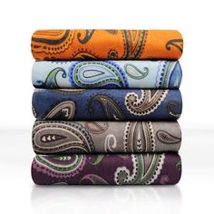 four different colored paisley print sheets stacked on top of each other in various sizes and colors