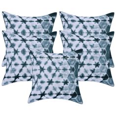 four blue and white pillows with black designs on the front, one is made from tie dye