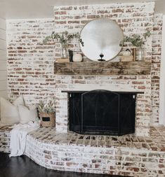 a brick fireplace with a mirror above it