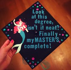 a decorated cap that says, look at this degree isn't it neat? finally my master's complete