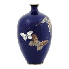 a blue vase with butterflies painted on it