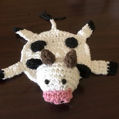 a crocheted cow head on a table