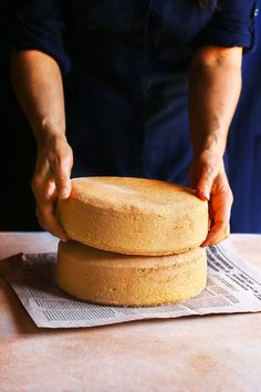 a person is placing some cake on top of each other