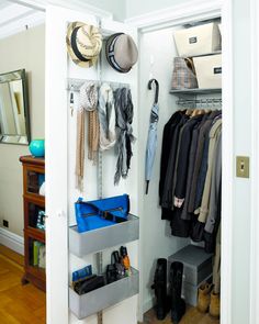 an open closet with clothes and hats hanging on the wall next to a shoe rack