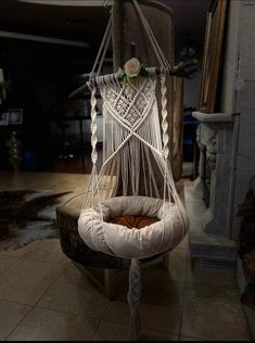 a white hammock hanging from the ceiling