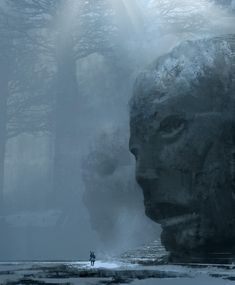 a man standing next to a giant statue in the middle of a snow covered forest