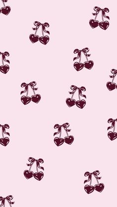 cherries with bows and hearts on a pink background seamless wallpaper or fabric