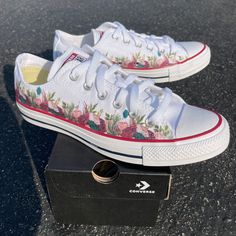 "These White Slip On Vans have an adorable and sweet flower design.  These are the perfect and comfortable gift for wearing on the big day while also enjoying them after the fact while out for brunch and reminiscing on saying \"I Do\". These shoes are also perfect for your wedding party's flower girl, ring bearer, brides maids, etc. We buy each pair of shoes BRAND NEW. Each pair is made to order, please make sure you put in the correct shoe size before you check out. The ink is permanent and will never come off, fade away, or peel off. Made in the USA. This price includes everything: shoes, artwork, and shipping. Thanks for stopping by our Etsy shop! Please message me with any questions! Because the artwork is custom made for you, there are no exchanges or returns. If you have any issues w White Wedding Sneakers For Summer, Lace-up Pink Wedding Shoes, Spring Wedding Shoes With Flower Design, Spring Wedding Sneakers With Round Toe, Spring Wedding Shoes With Round Toe For Bridal Shower, Summer White Lace-up Wedding Shoes, White Lace-up Summer Wedding Shoes, White Lace-up Wedding Shoes For Summer, Spring Wedding Shoes For Bridal Shower