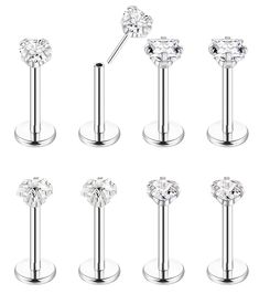 six different types of surgical piercings with clear crystal balls on each end and an attached bar