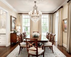 a formal dining room with chandelier and chairs