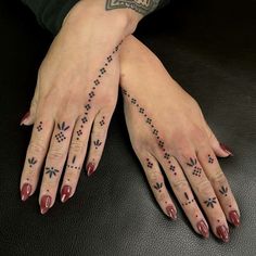 a woman's hands with tattoos on them and her hand holding the other arm