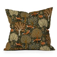 a pillow with foxes and trees on it