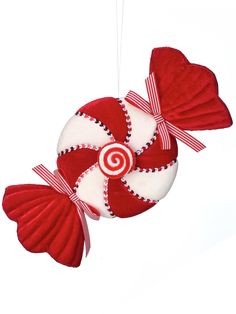 a red and white candy ornament hanging from a string