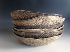 four bowls are stacked on top of each other