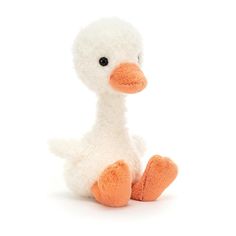 a stuffed duck sitting on the ground with its legs crossed and eyes wide open, in front of a white background