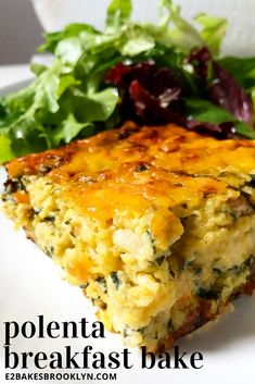 a white plate topped with a slice of quiche next to a leafy green salad