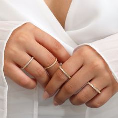 a woman's hand with two rings on it