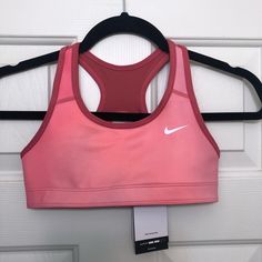 Enhance Your Workout With This Nike Dri-Fit Sports Bra Designed For Girls In Size S. The Pullover Style And Racerback Strap Type Provide Comfort And Support For Moderate Activities. The Full Cup Coverage And Wireless Underwire Type Offer A Natural Fit, While The Solid Pattern And Pink Color Add A Touch Of Style. Made Of A Blend Of Polyester And Spandex, This Nike Sports Bra Is Machine Washable And Easy To Maintain. The Bra Features The Nike Dri-Fit Technology That Helps Keep You Dry And Comforta Stretch Sports Bra For Workout, Nike Pink Sports Bra For Sports Season, Pink Breathable Sports Bra For Sports Events, Pink Breathable Sports Bra, Casual Pink Sports Bra For Light Activities, Casual Pink Sports Bra For Exercise, Casual Pink Sweat-resistant Sports Bra, Casual Pink Sports Bra, Nike Pink Sports Bra For Light Sports