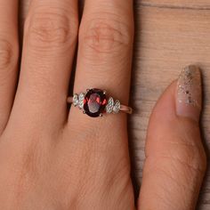 It is natural garnet ring. The main stone is 7mm*9 mm oval cut.weight about 2.33 carats. The basic metal is sterling silver and plated with rhodium. To change the metal to a solid gold (white/rose) or platinum is also available, please ask for a quotation if you want. You can also go to my shop Home for more elegant rings: https://www.etsy.com/shop/godjewelry?ref=hdr_shop_menu Emerald is January birthstone More garnet rings: https://www.etsy.com/shop/godjewelry?ref=l2-shopheader-name§ion_id=2070 Oval Garnet Birthstone Ring For Anniversary, Oval Garnet White Gold Jewelry, Silver Oval Garnet Birthstone Ring, Oval Silver Garnet Birthstone Ring, Oval Garnet Birthstone Ring In Silver, Oval Garnet Ring In Silver, Elegant Rings, Swiss Blue Topaz Ring, January Birthstone Rings