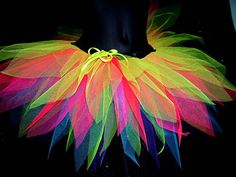 a woman's waist with colorful feathers on it