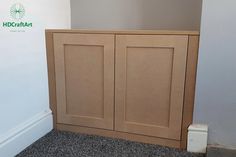 an empty room with a cabinet in the corner and carpet on the floor next to it