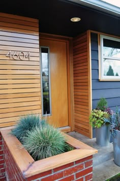 two planters on the side of a house