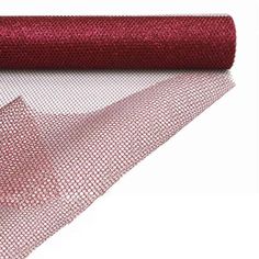 a roll of red mesh fabric on top of a white surface with one roll in the middle