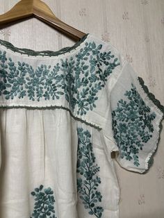 Mexican style hand-embroidered blouse is made from 100% cotton soft and light which makes you so comfortable. Split sleeve is tighten with hand crochet. Color : Ivory/ green embroidery Measurement is laid flat in inches (approximately) - one size fits most (S-L). Loose style depend on preferred fit - arm hole : 20" - bust : 42" - sleeve length : 7.5" - waist : open - hips : 52" - shoulder to bottom hem : 27" More beautiful blouses link : http://www.etsy.com/shop/chokethai?section_id=11663201 Bohemian Embroidered Relaxed Fit Blouse, Embroidered Bohemian Peasant Top With Relaxed Fit, Bohemian Embroidered Peasant Top With Relaxed Fit, Bohemian Embroidered Relaxed Fit Peasant Top, Bohemian Embroidered Cotton Top With Relaxed Fit, Bohemian Style Embroidered Cotton Top With Relaxed Fit, Relaxed Fit Bohemian Embroidered Cotton Top, Bohemian Style Relaxed Fit Embroidered Cotton Top, Bohemian Green Embroidered Hem Top