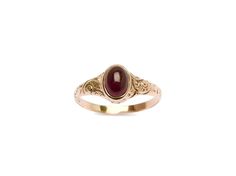 Check out this darling garnet cab, set into an etched rosy gold 10k band. This handsome ring features a swirling design that arcs all along a tapered band. The center stone features a deep merlot garnet. There is an inscription on the inside of the ring that is hard to make out but is likely a commemorative dedication of some kind. The kind of quintessential Victorian ring everyone is on the hunt for- a classic!. Elegant Engraved Ring With Oval Cabochon For Formal Occasions, Elegant Engraved Oval Cabochon Ring For Formal Occasions, Elegant Formal Engraved Oval Cabochon Ring, Elegant Engraved Ring With Birthstone For Formal Occasions, Elegant Engraved Ruby Ring In Yellow Gold, Elegant Engraved Yellow Gold Ruby Ring, Elegant Oval Ruby Ring With Intaglio, Elegant Ruby Intaglio Ring For Anniversary, Engraved Oval Ruby Ring Fine Jewelry