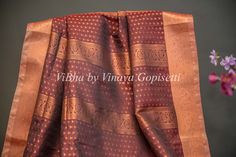 Dark Brown and Grey Copper Zari Kanchi Soft Silk Saree and Blouse. Enhance your elegance with our Dark Brown and Grey Copper Zari Kanchi Soft Silk Saree and Blouse. Made with high quality silk and adorned with intricate zari work, this saree is perfect for special occasions. The soft fabric ensures comfort while the rich colors add a touch of sophistication. The accompanying saree blouse is tailored and embellished with handcrafted dori and tassels at the back. The attention to detail further en Formal Silk Dupatta With Motifs, Formal Saree With Motifs, Elegant Tissue Silk Saree With Motifs, Formal Art Silk Saree With Motifs, Formal Silk Saree With Motifs, Elegant Cotton Silk Blouse Piece With Motifs, Brown Raw Silk Saree With Zari Work, Brown Saree With Zari Weaving For Diwali, Brown Silk Saree With Zari Work