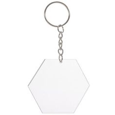 a white hexagonal keychain with a chain hanging from the front and back