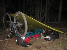 there is a tent and bike in the woods