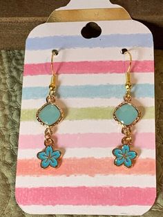 Super cute summer vibe earrings! Perfect for the beach or any occasion really. Handcrafted by me with all new hypo allergenic materials. Gold tone with plastic blue gems in an adorable dangle from a fish hook style earring. My home is pet and smoke free, and all packaging will be new. Summer Blue Hypoallergenic Jewelry, Cute Summer Flower Drop Earrings, Cute Summer Flower Earrings For Pierced Ears, Cute Adjustable Earrings For The Beach, Cute Drop Earrings For Summer, Blue Drop Earrings Cute Style, Cute Dangle Flower Earrings For Summer, Nickel Free Blue Earrings For Summer, Light Blue Drop Earrings For Summer