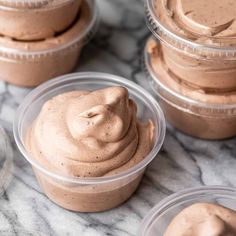 several small plastic containers filled with chocolate pudding