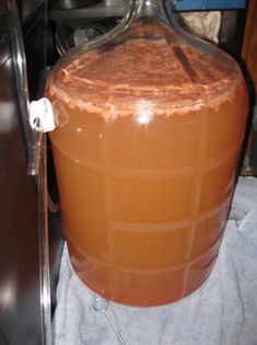 a large brown jug sitting on top of a towel