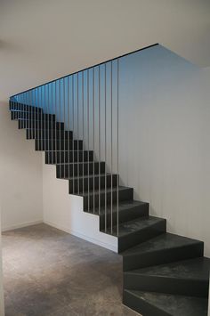 a black and white staircase in an empty room