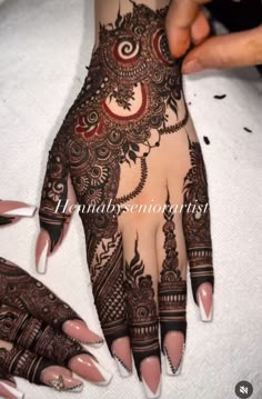 someone is getting their hands painted with henna designs for the brides to show off