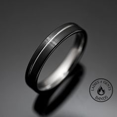 a black and white wedding ring on a gray background