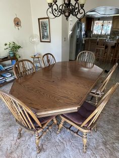 a dining room table with six chairs and a chandelier