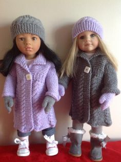 two dolls are standing next to each other