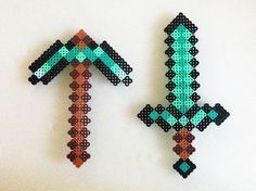 two pieces of beaded art made to look like arrows on a white wall, one is green and the other is brown