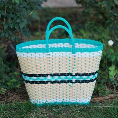 "Made from handwoven plastic by Valentin Ortega from Acambay, Mexico.  Each one is made individually with love and care.   Use this reusable and eco-friendly tote bag as a shopping bag for farmer's markets, great for the pool or the beach. Details:  * Tote measurements: 12 W ( lower part) 17\" W (top)  12.5 High.    * Waterproof-washable  * Material: Recycle Plastic  * All items are shipped from the US All Mi Mundo Mexicano items are 100% handmade by artisans in Mexico. Each stitch and item is c Plastic Tote Beach Bag, Blue Plastic Beach Bag, Blue Plastic Beach Bags, Beach Tote Bag In Plastic, Rectangular Recyclable Beach Bag For Vacation, Recyclable Rectangular Beach Bag, Plastic Beach Tote Bag, Plastic Tote Bag For Beach, Reusable Rectangular Beach Bag